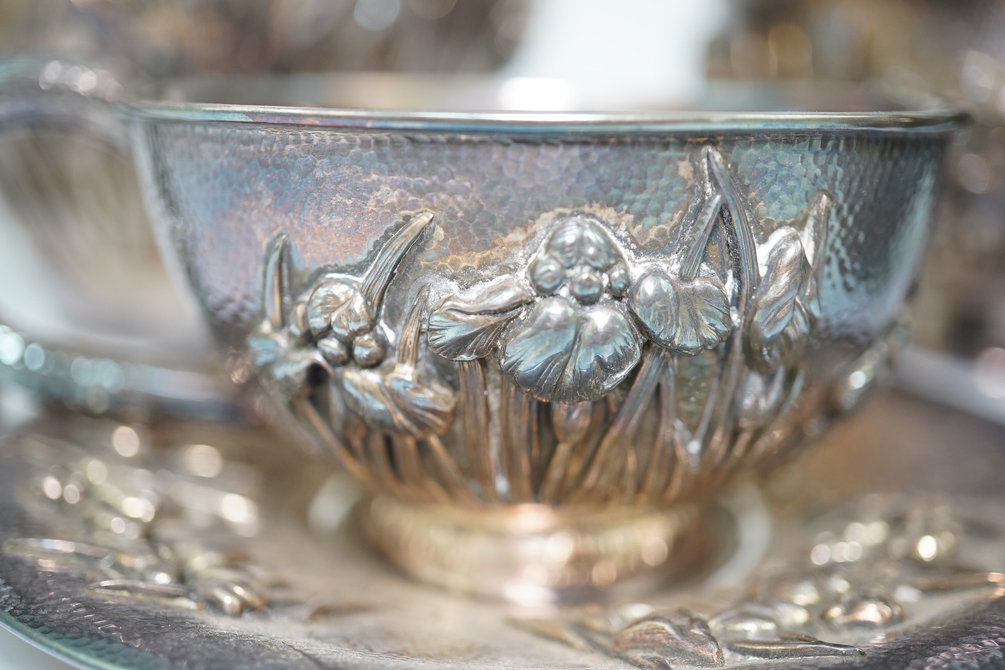 An early 20th century Japanese Meiji period planished silver matched? part tea set comprising a tea caddy with covers, sugar bowl, cream jug and tea cup and saucer